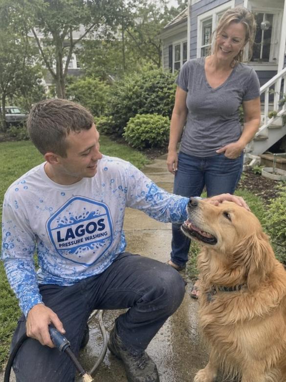 Lagos Pressure Washing technician with a customer's dog