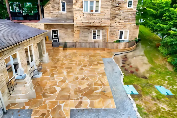 Stone patio and raised deck beside a home