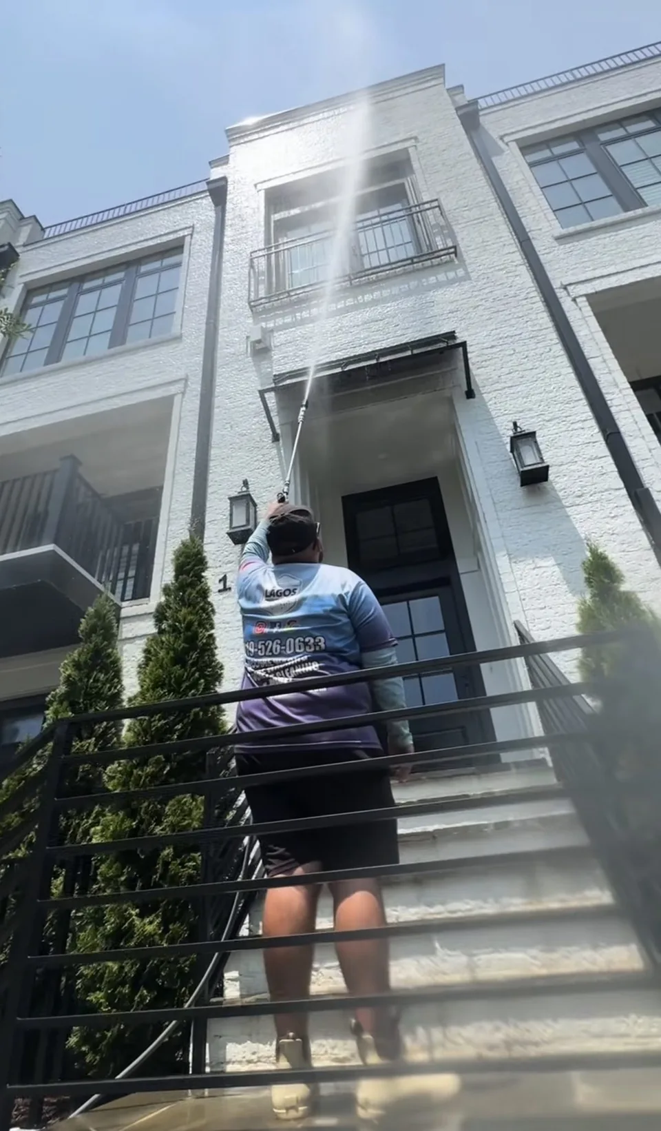 Lagos technician washing the exterior of a local home